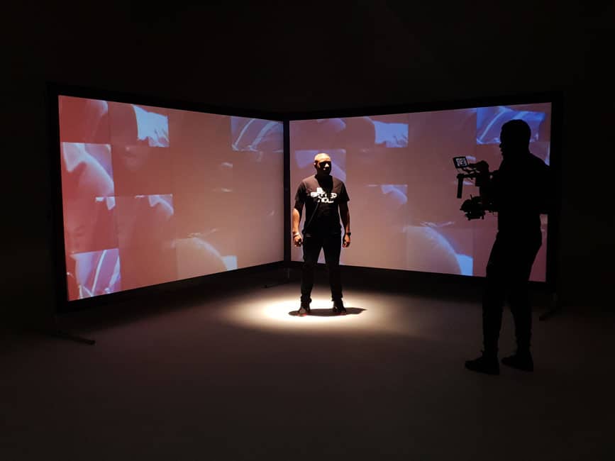 Performer and camera operator working with projected backgrounds in the studio