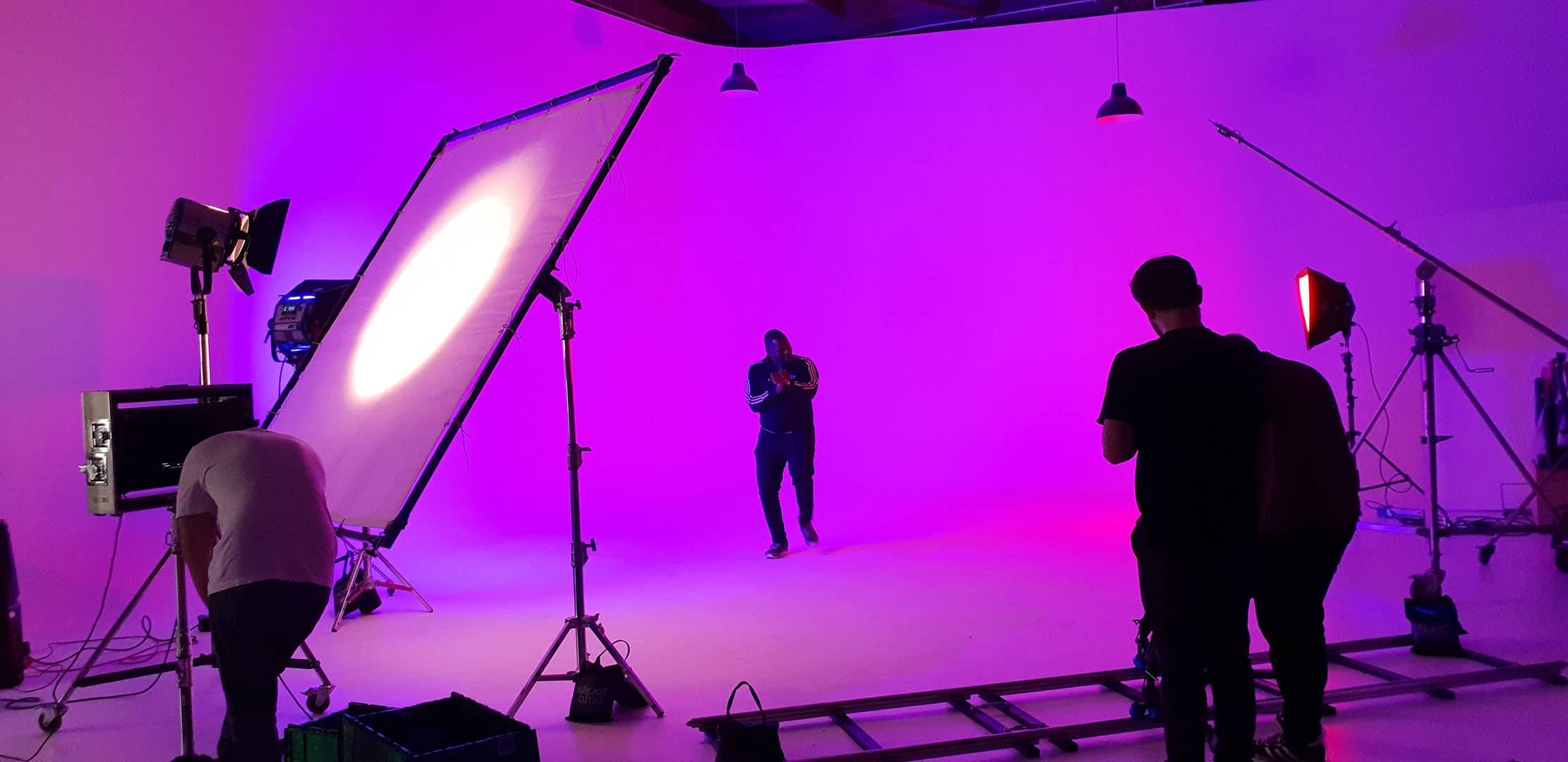 Cinema camera on a track and dolly with studio lights for a music video shoot at Cineview Studios London