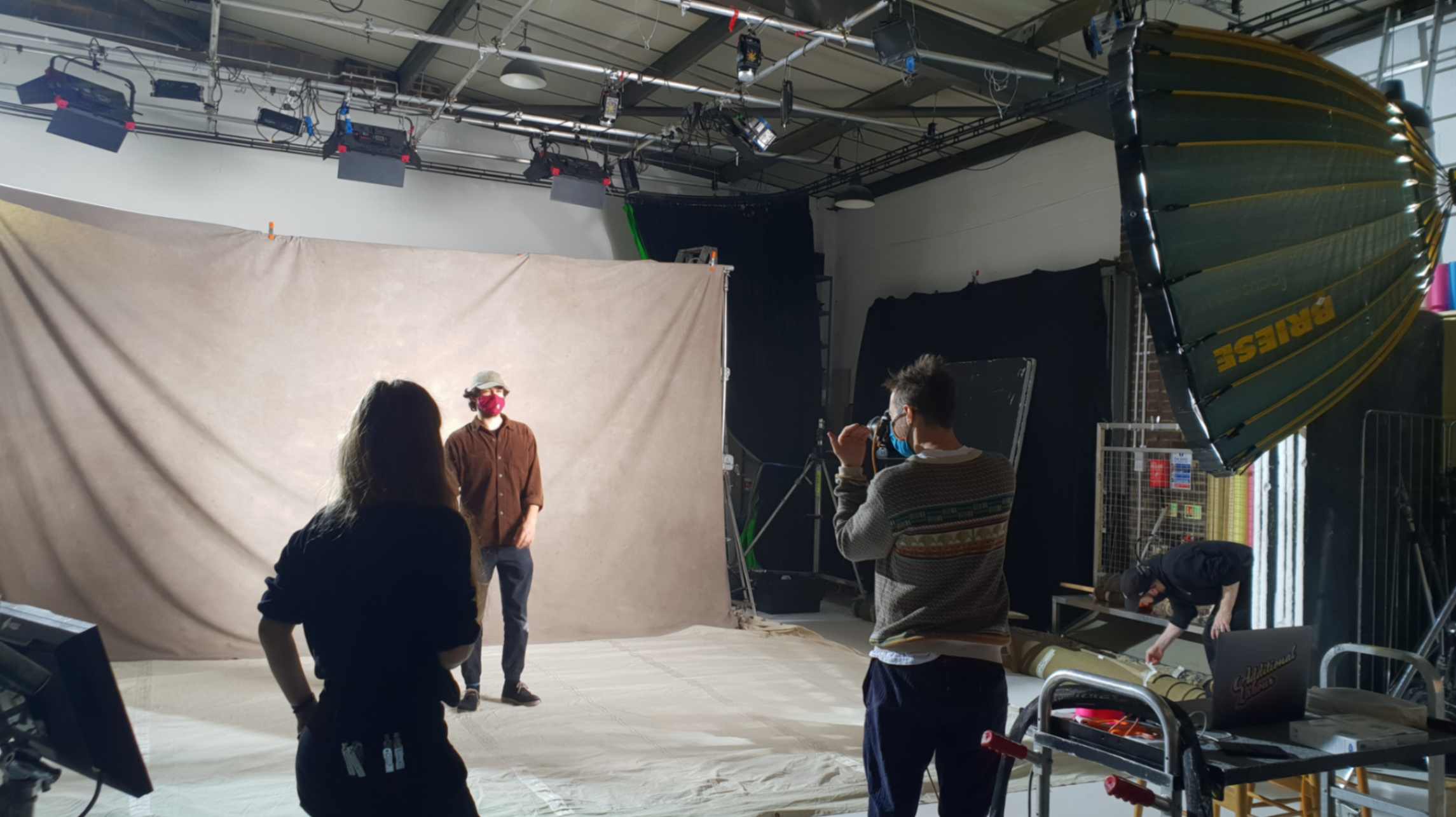 Crew member wearing mask in a film studio