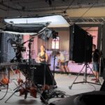 Creative film production team working in a modern studio environment during video filming