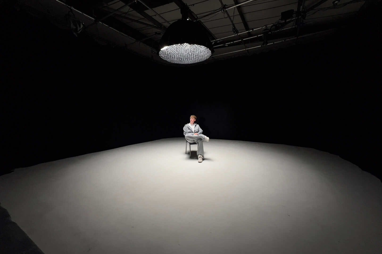 Dramatic low key lighting for a singer filmed inside the 360 degree blackout studio void