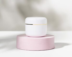 Clean cosmetic product view on a pink pedestal