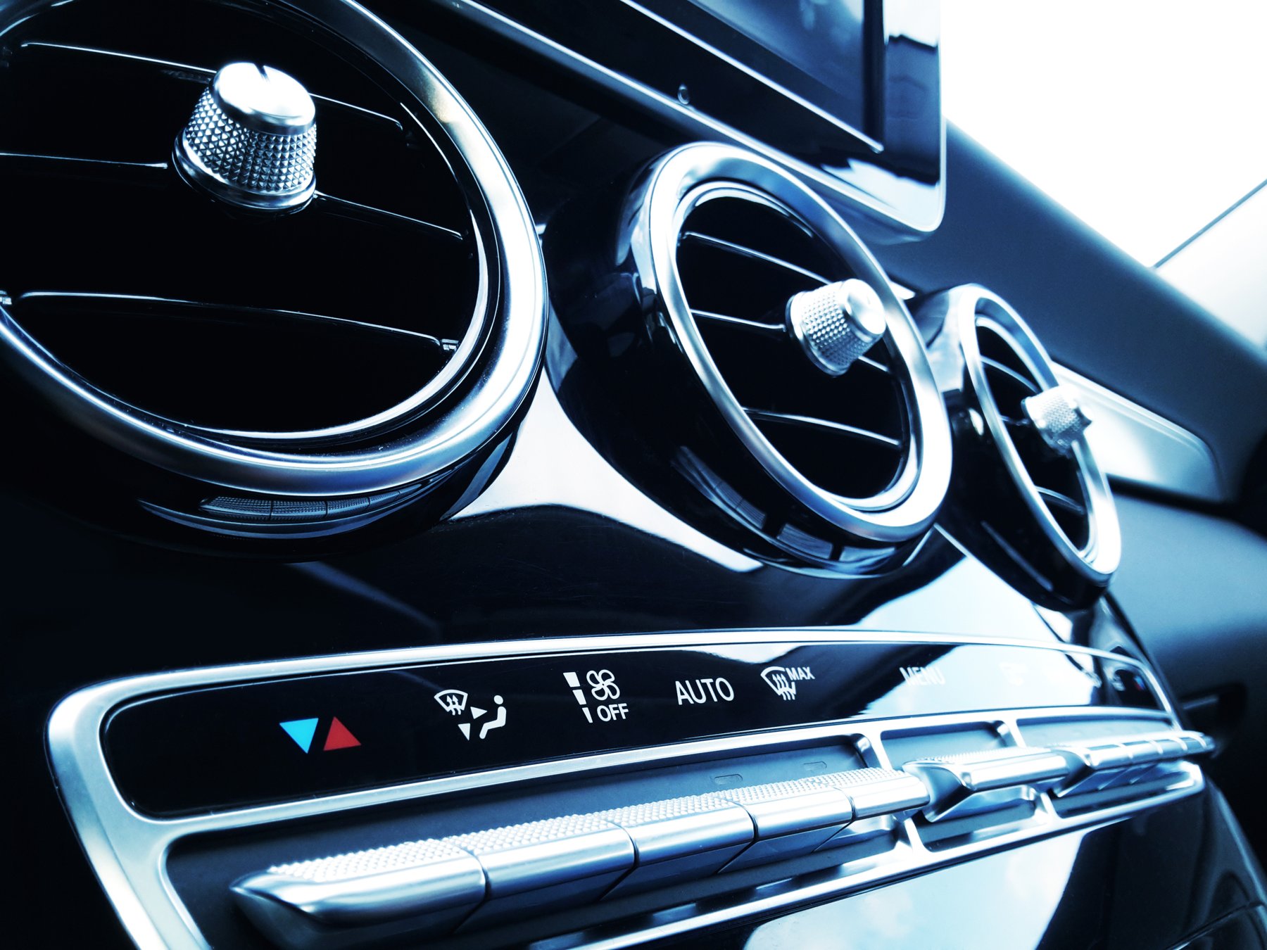 Close-up of vehicle air vents and climate controls