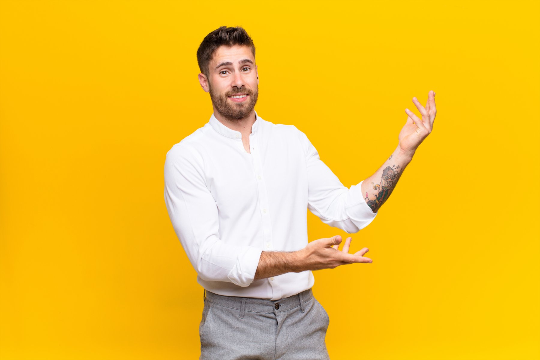 Presenter demonstrating a gesture against a yellow background