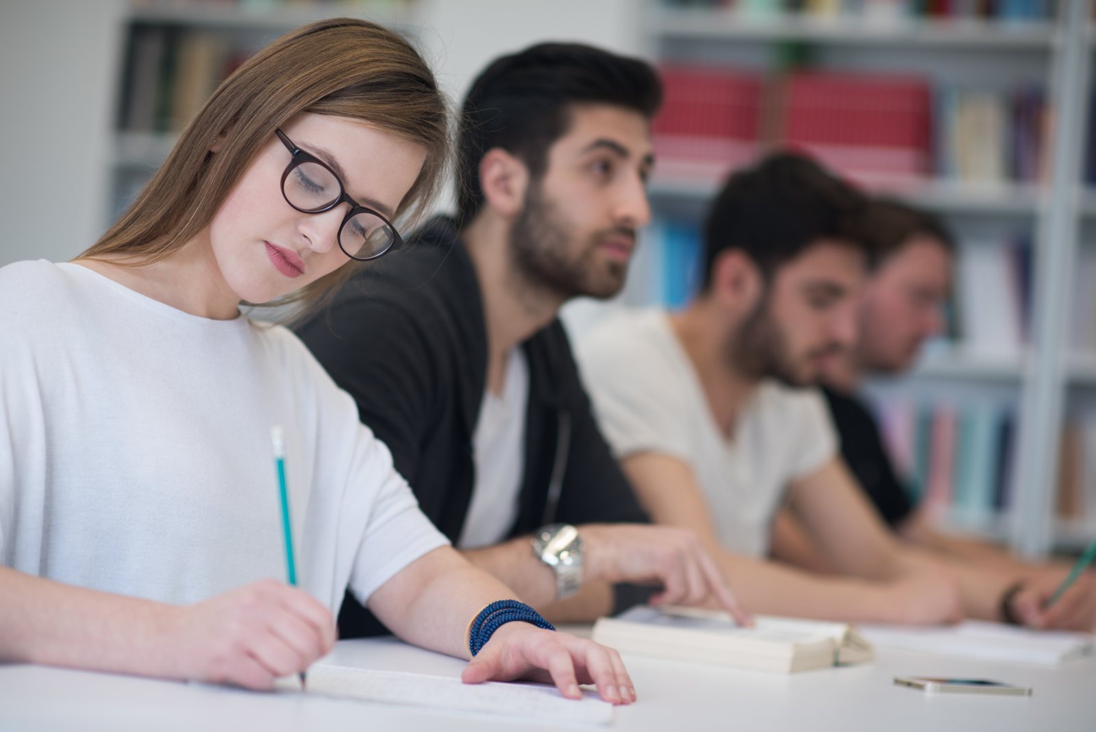 Students writing and studying together