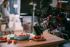 Close-up of a camera filming styled food for a commercial