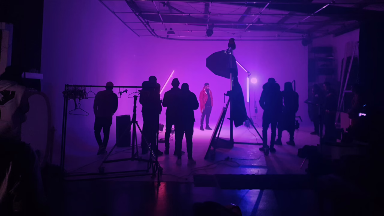 Music video crew filming a performer under purple lighting in the infinity cove at Cineview Studios London