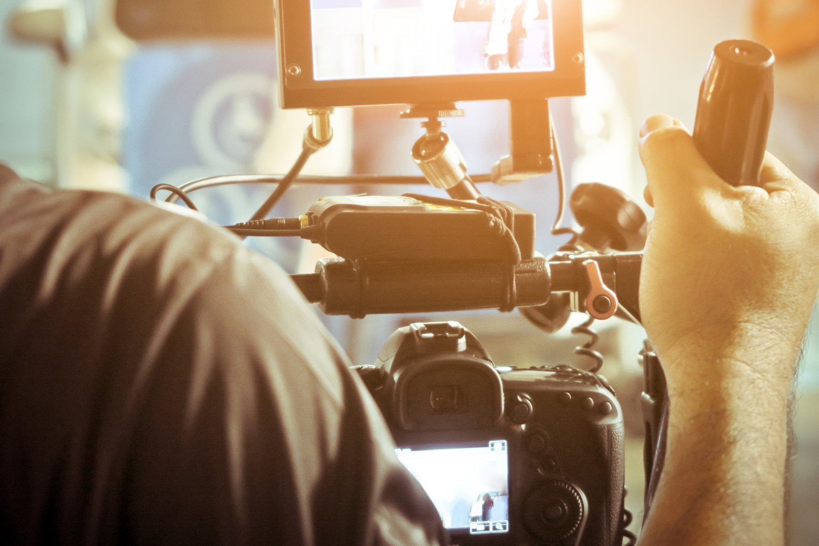 Camera operator adjusting a professional video camera
