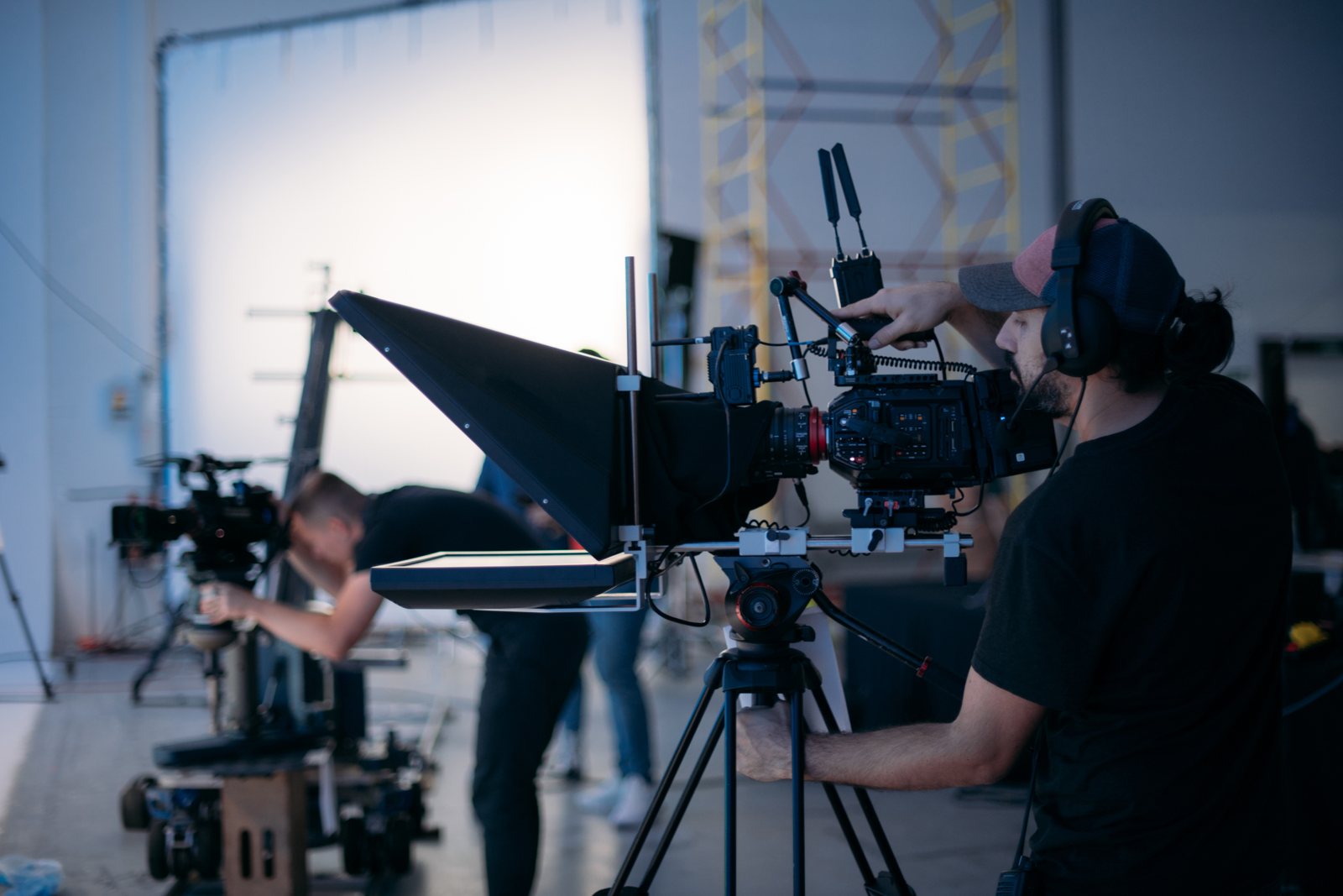 Camera operator composing a shot on a cinema camera