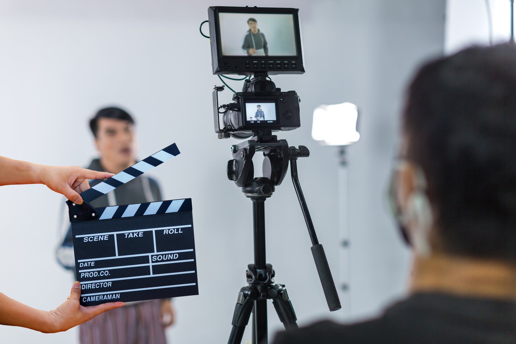 Clapperboard and camera monitor during a talking-head recording