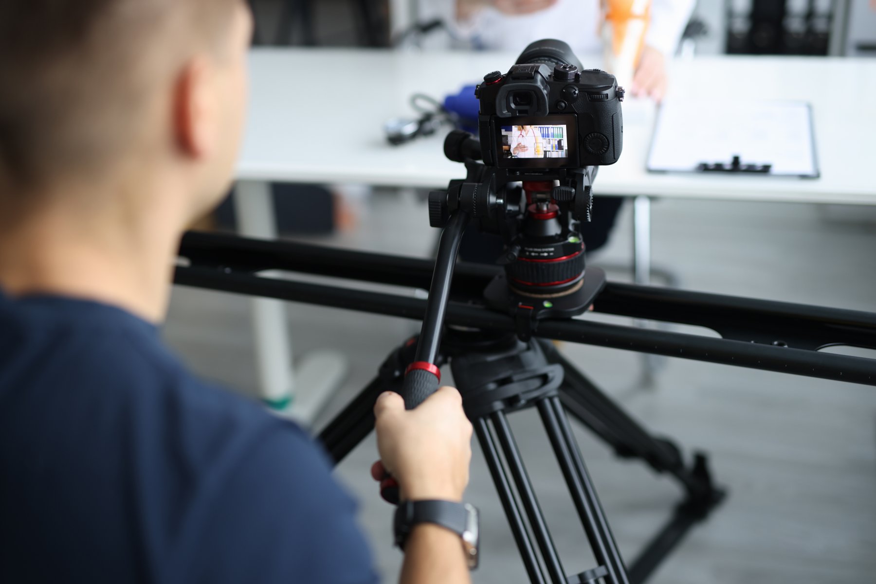 Videographer framing a professional interview recording