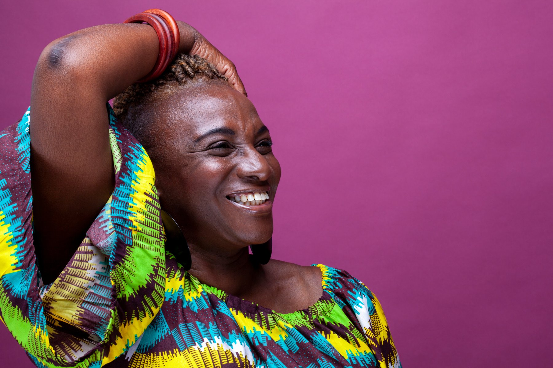 Smiling model portrait against a colourful background
