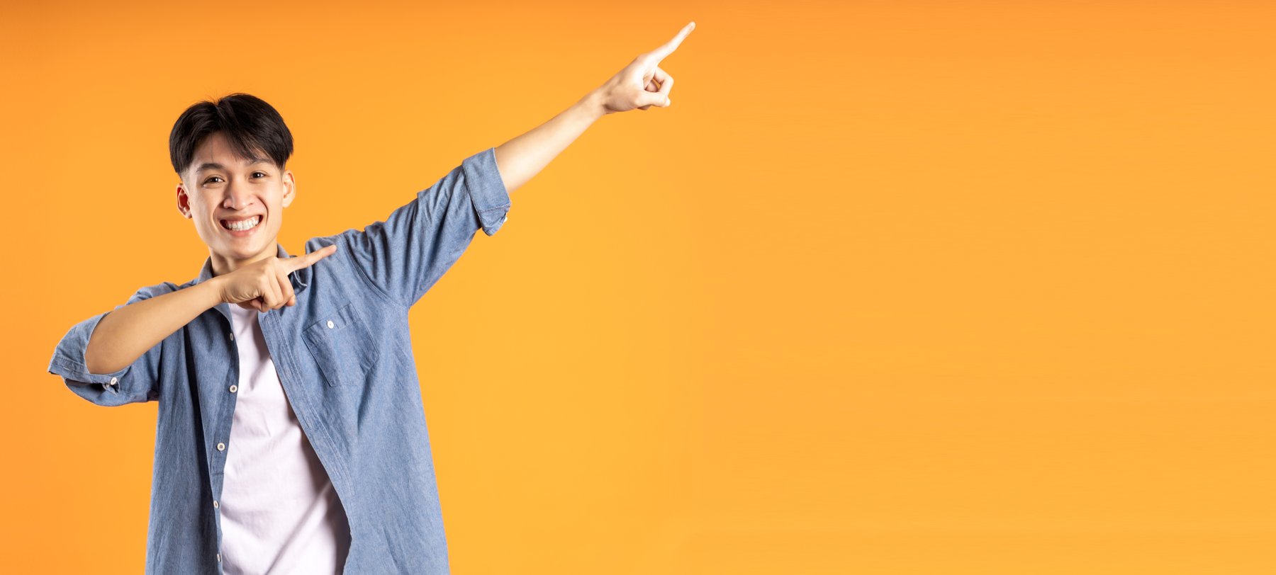 Expressive lifestyle portrait on an orange backdrop
