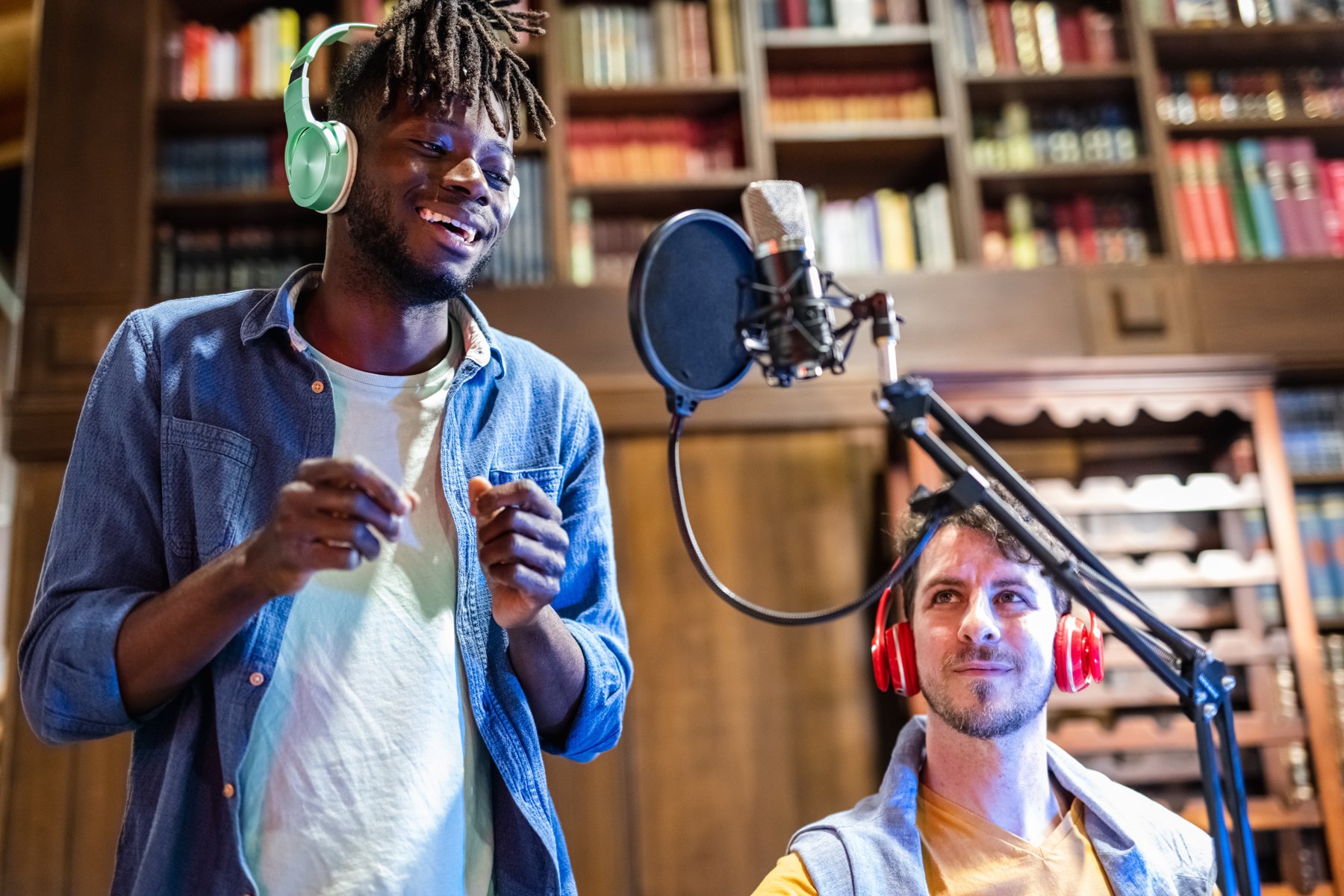 Vocal artist performing beside a microphone and headphones