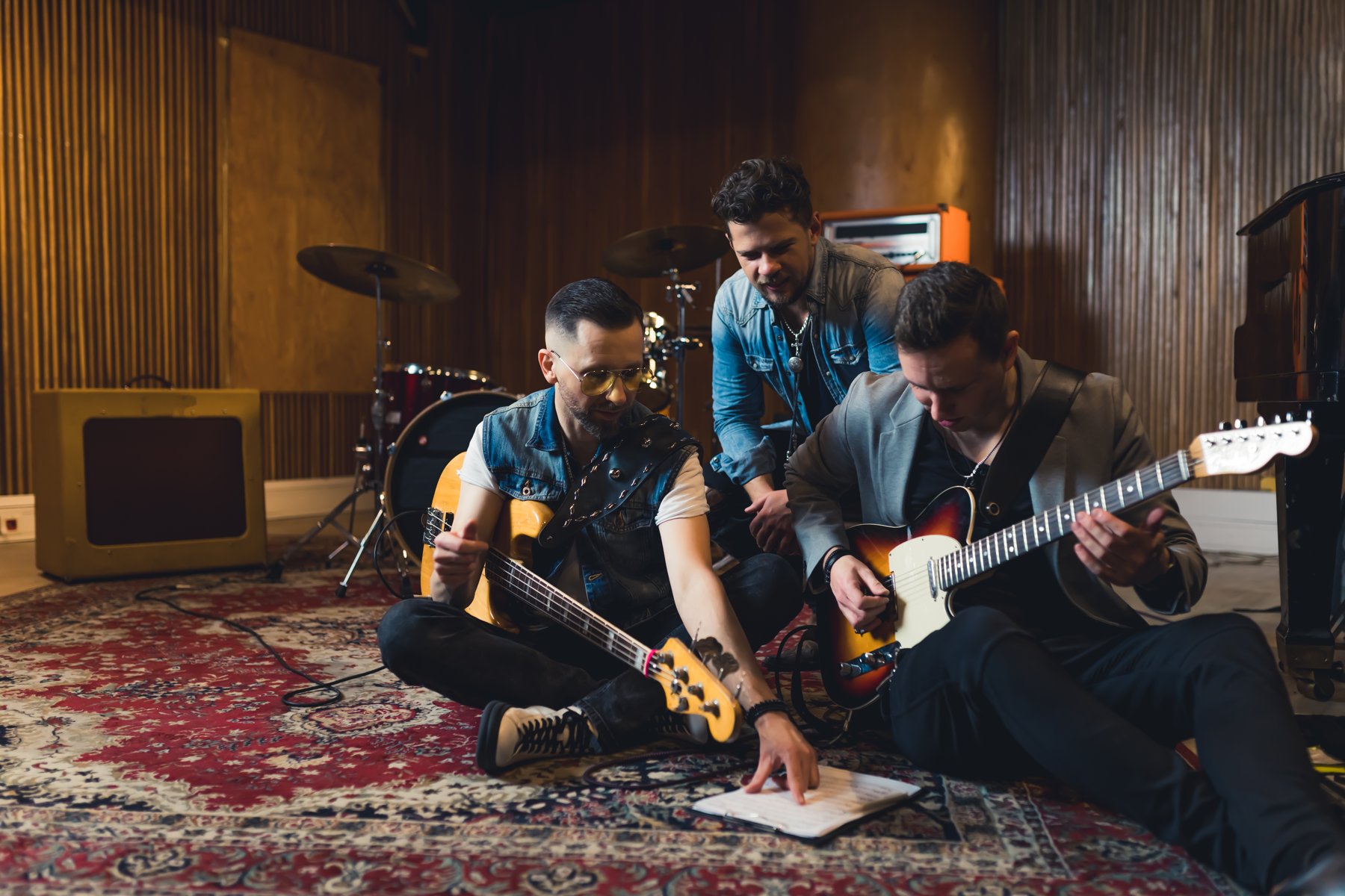 Musicians rehearsing together with guitars and drums