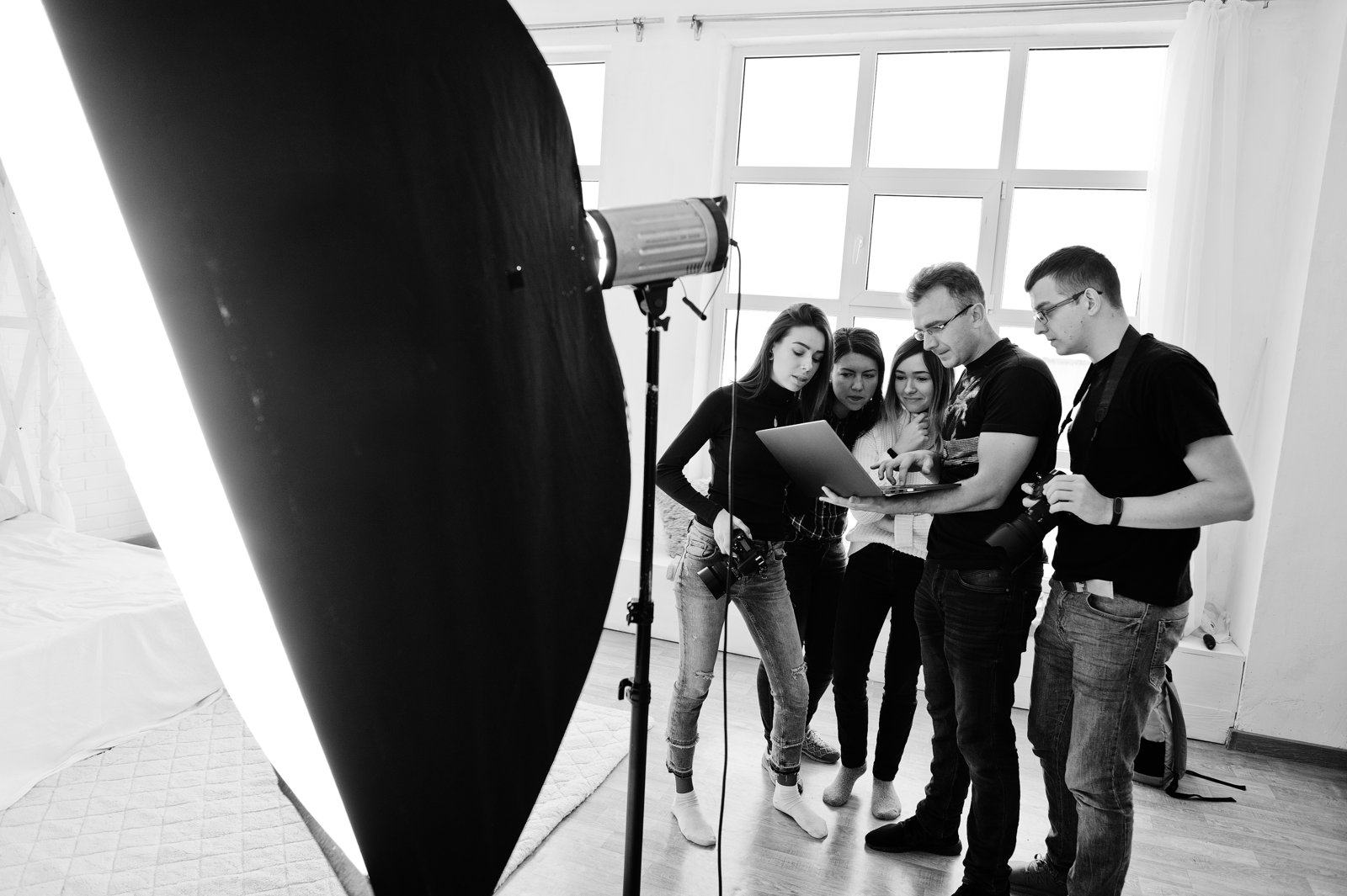 Photography team reviewing images on a laptop
