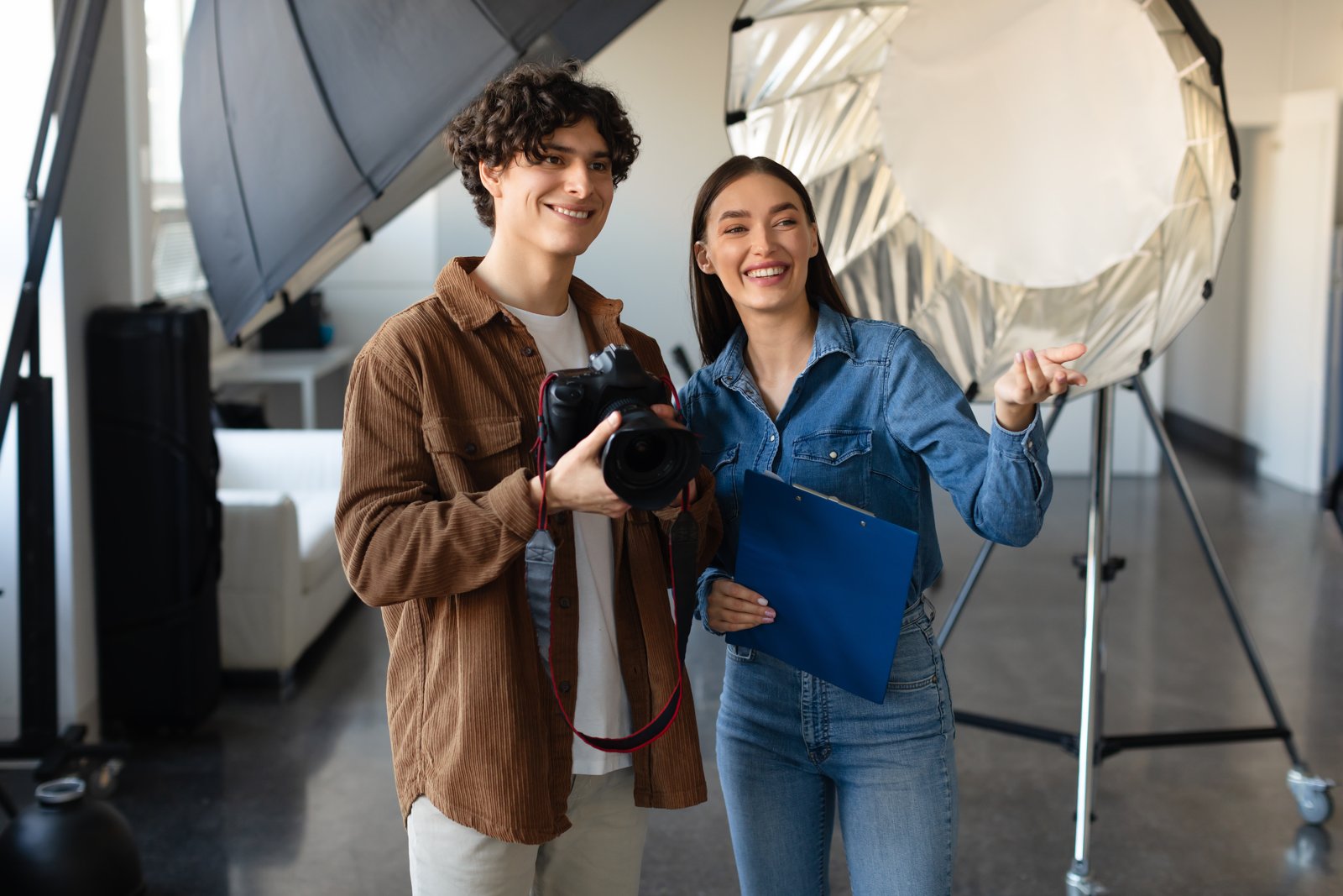 Photographer and assistant preparing for a studio shoot
