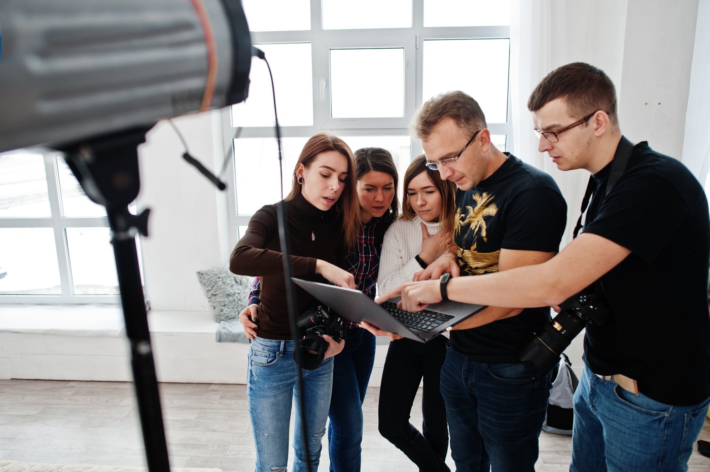 Production team reviewing a shoot together on a laptop