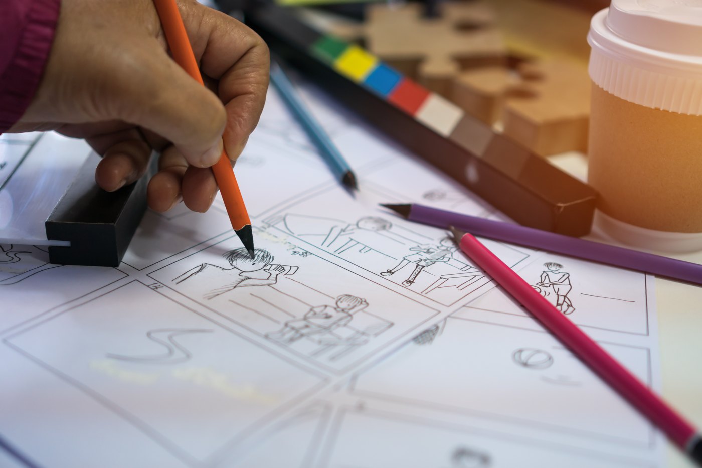 Hand drawing a storyboard with a pencil before production