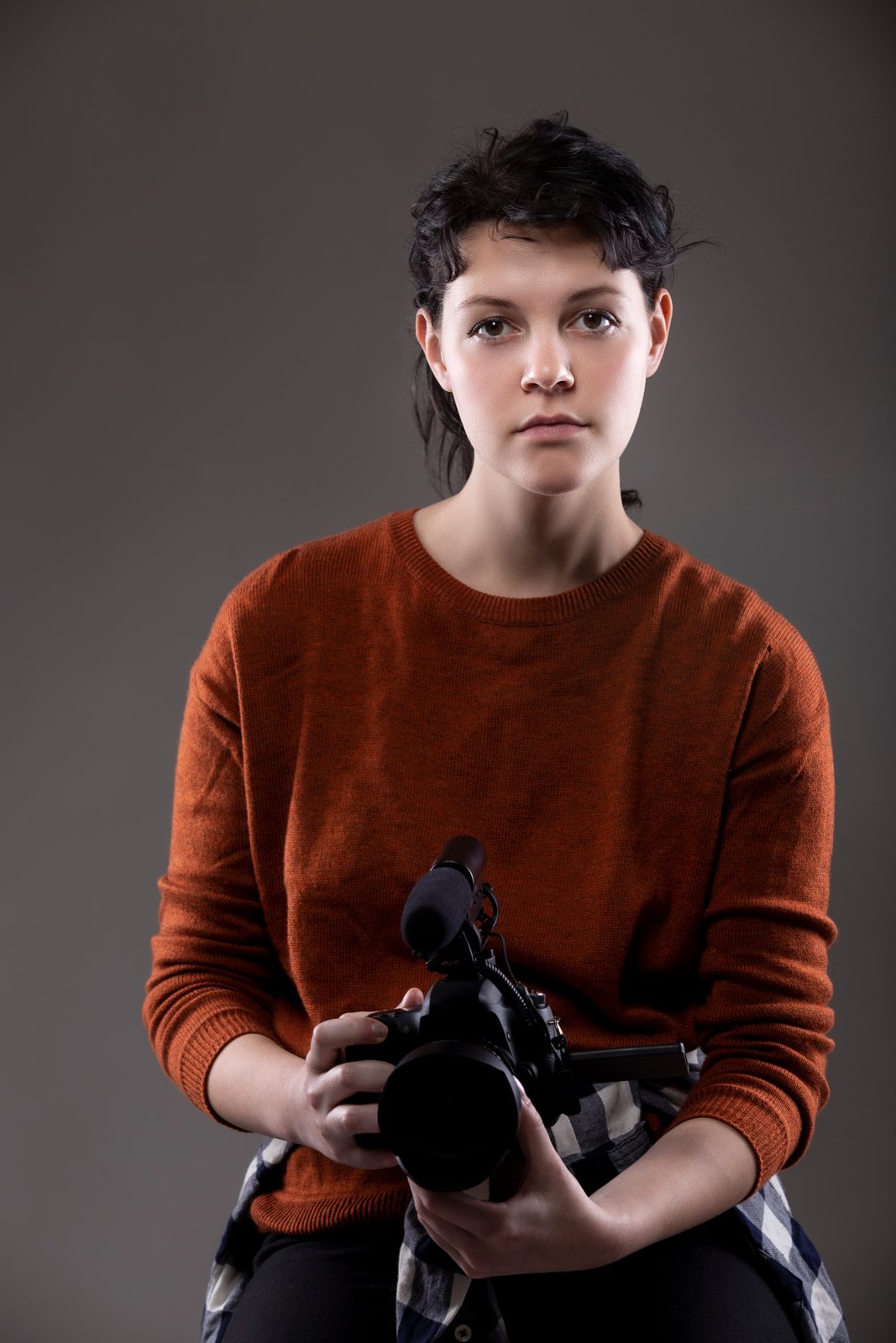 Young camera operator holding a video camera
