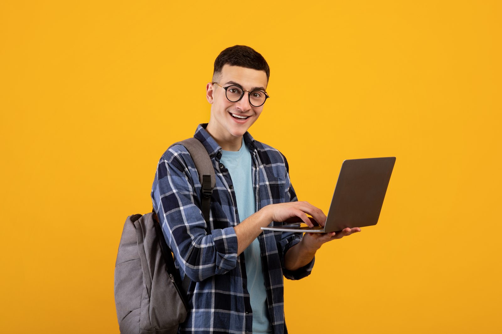 Young student reviewing work on a laptop