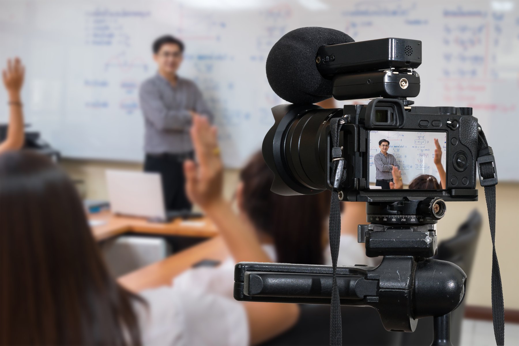 A video camera recording a teacher presenting a classroom lesson
