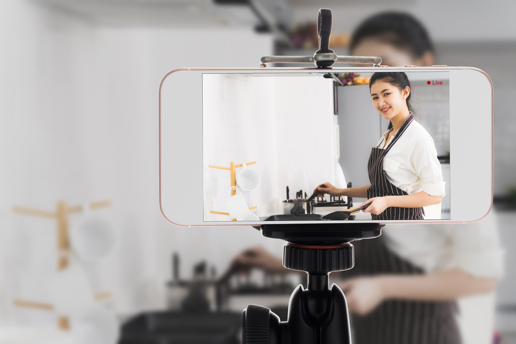 A phone recording a cooking tutorial demonstration