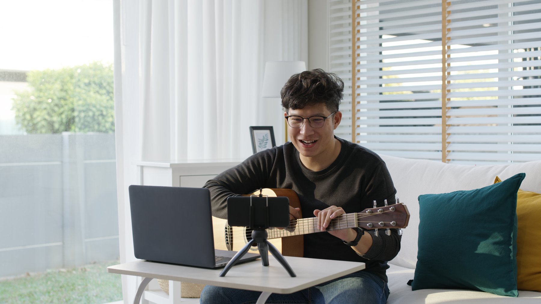 A musician recording a guitar tutorial