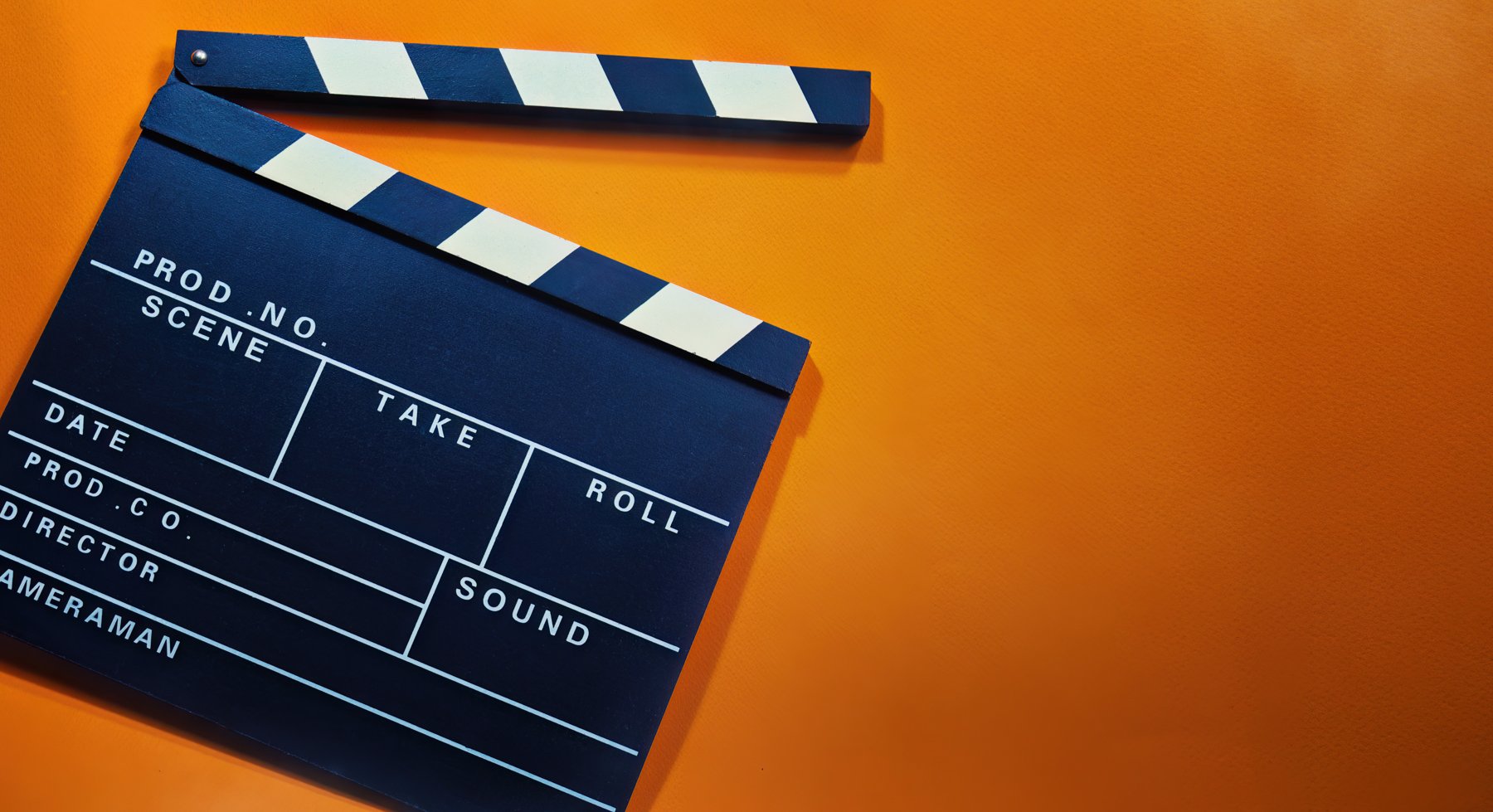 Clapperboard against an orange background