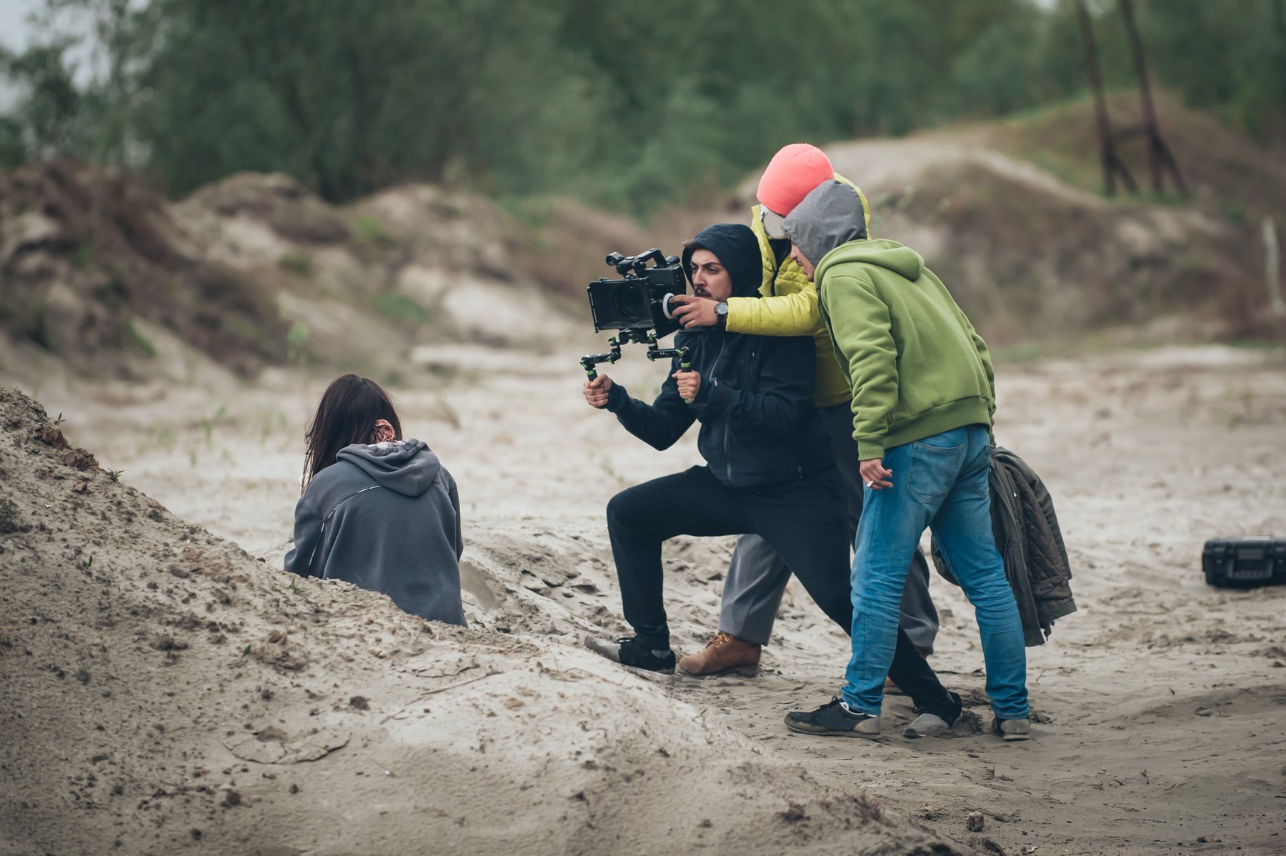 Performer and camera team recording a narrative scene on location
